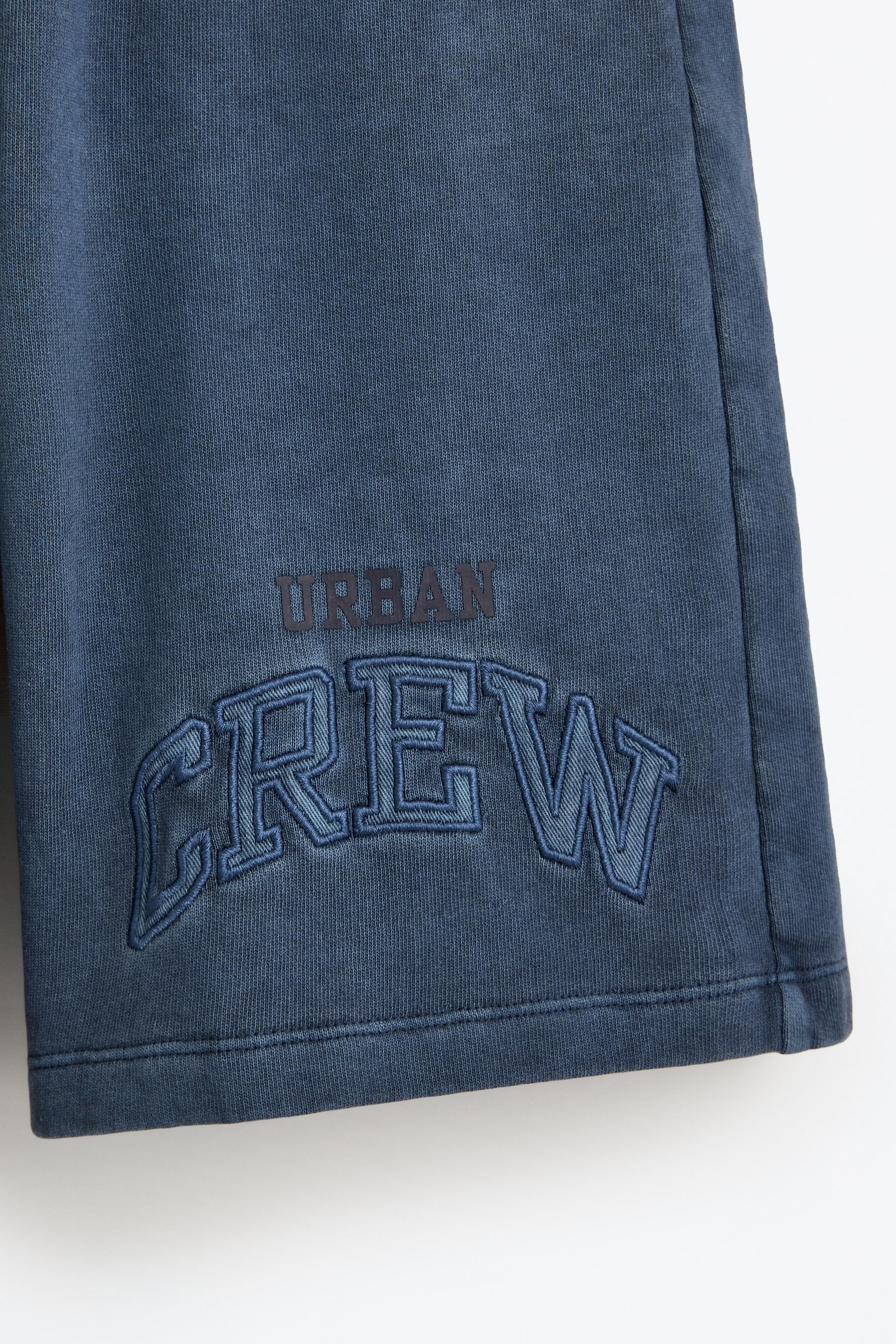 Bermuda shorts with text patches