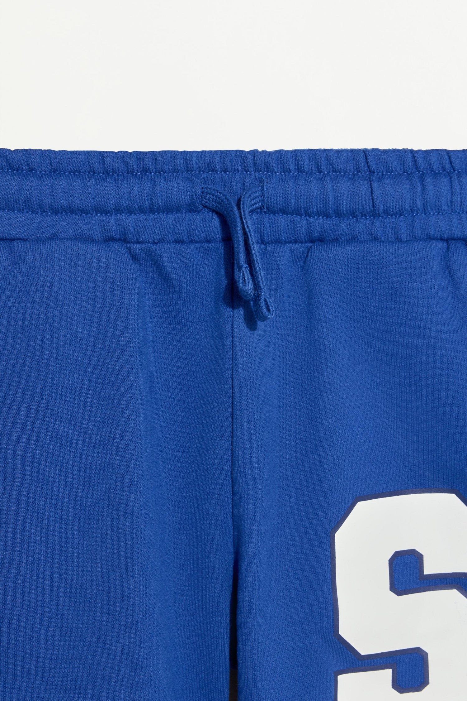 Plush Bermuda shorts with text