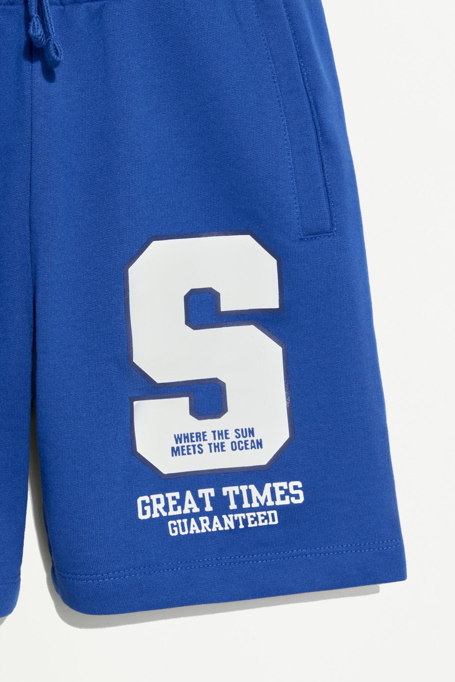 Plush Bermuda shorts with text