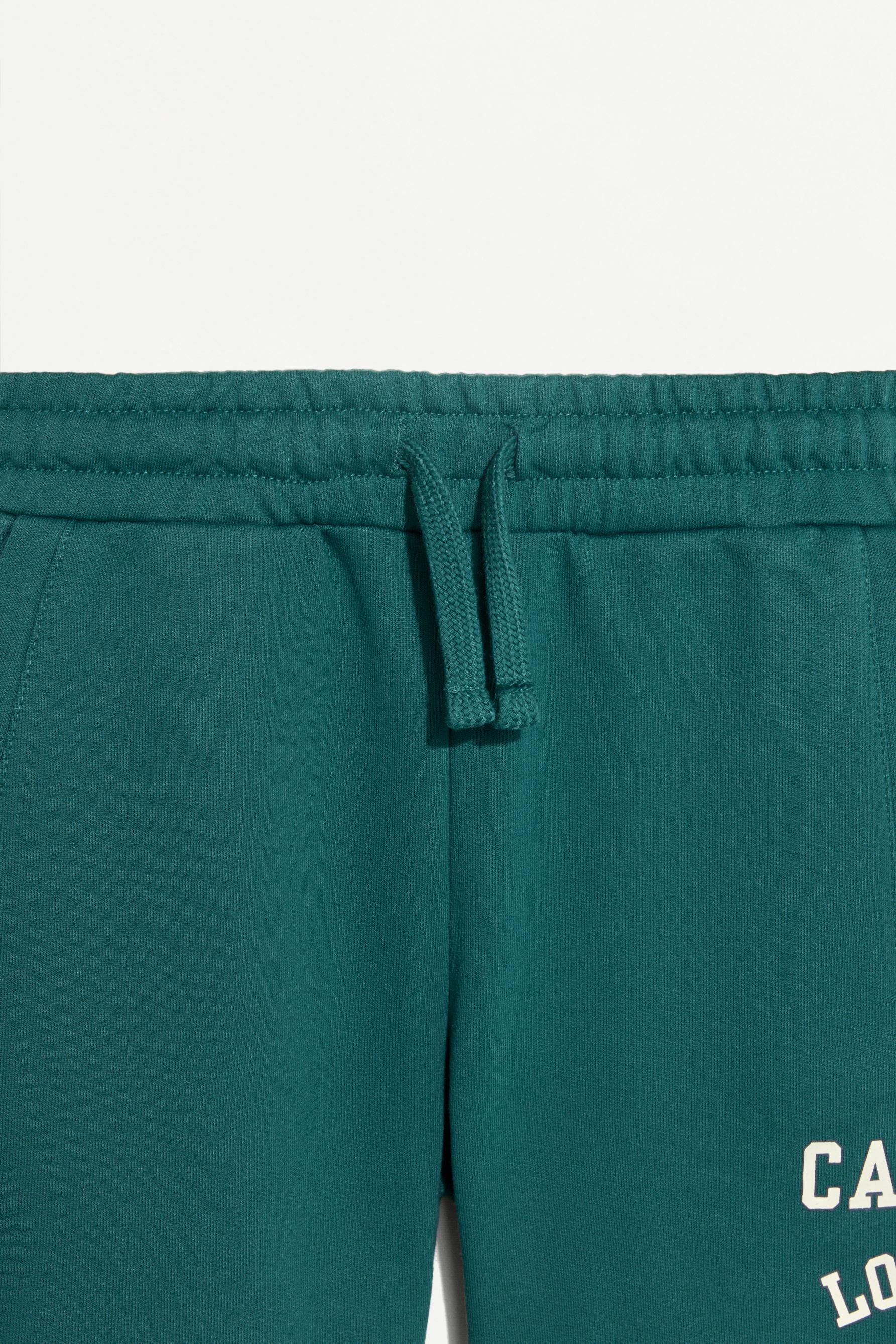 Plush Bermuda shorts with text