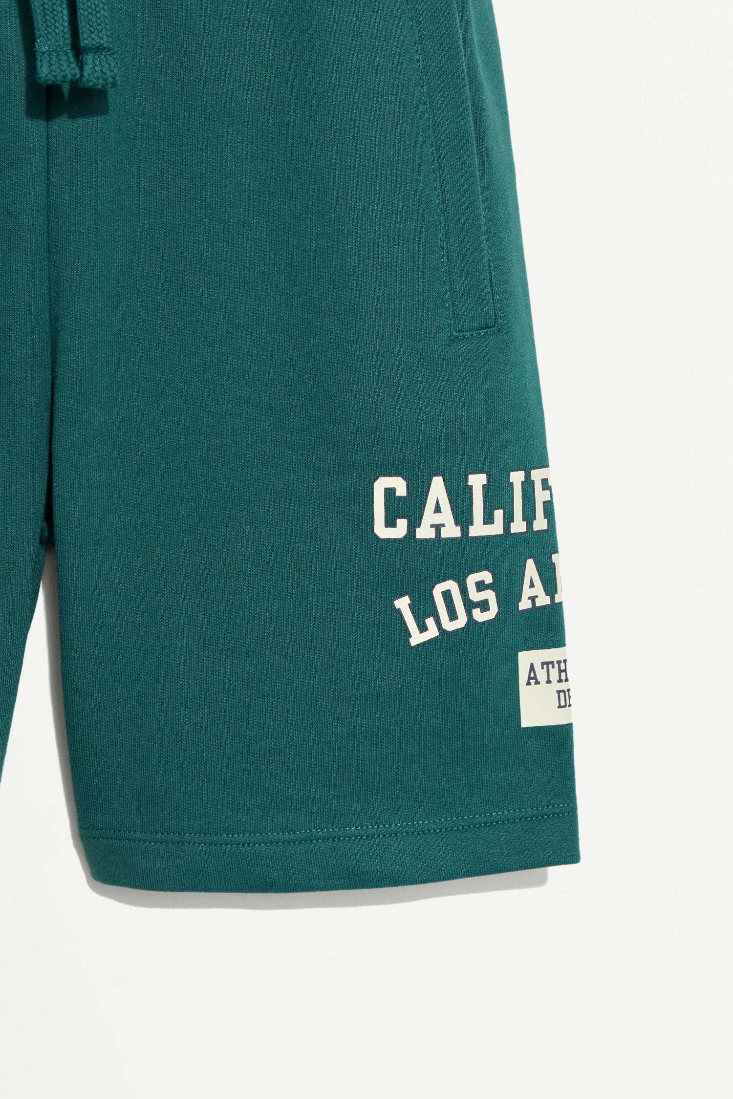 Plush Bermuda shorts with text