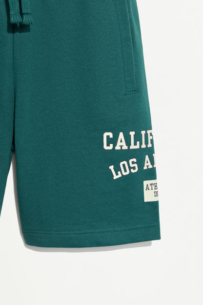 Plush Bermuda shorts with text