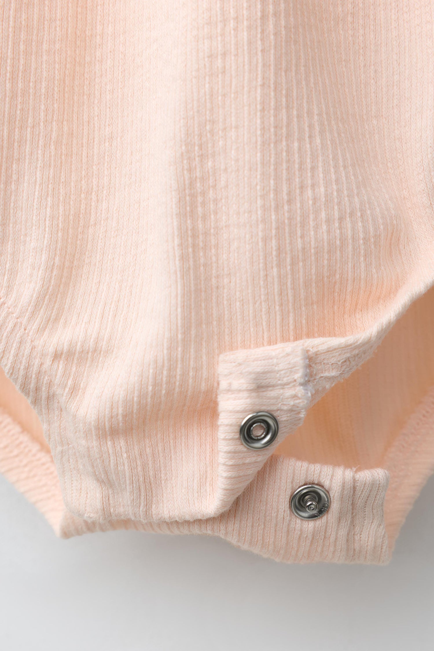EMBROIDERED SUN RUFFLE BODYSUIT
