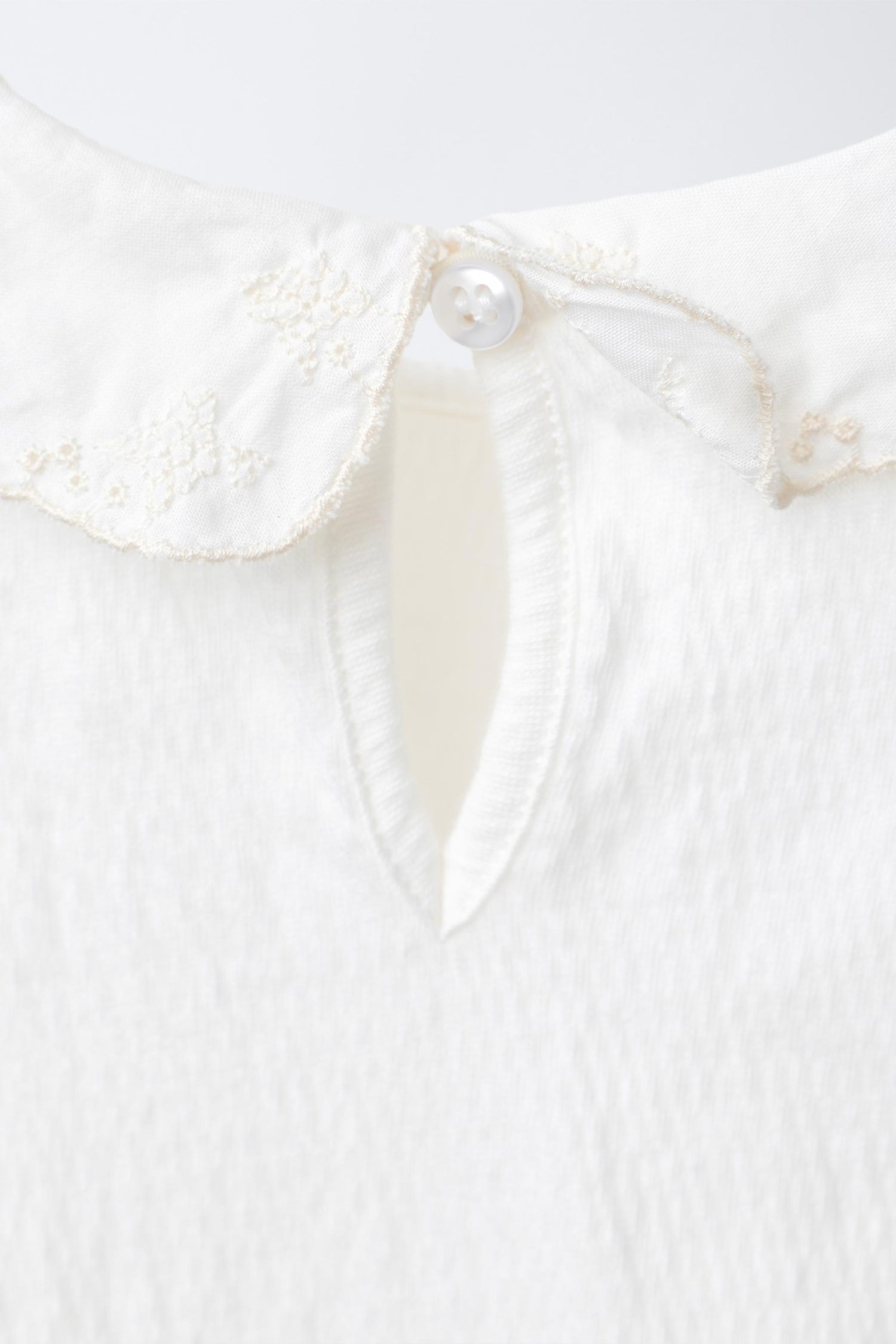BODYSUIT WITH PETER PAN COLLAR AND SWISS EMBROIDERY